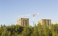 Construction crane and two construct buildings on blue sky Royalty Free Stock Photo