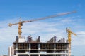 Construction crane and worker of building industry with blue sky Royalty Free Stock Photo