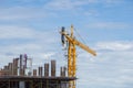 Construction crane and worker of building industry with blue sky Royalty Free Stock Photo