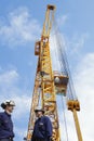 Construction crane with workers Royalty Free Stock Photo