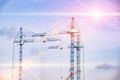 construction cranes against the backdrop of the sunny sky Royalty Free Stock Photo