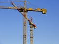 Construction cranes against the blue sky