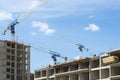 High construction cranes on a construction site with workers Royalty Free Stock Photo