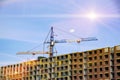 construction cranes against the backdrop of the sunny sky Royalty Free Stock Photo