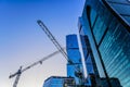 Construction cranes and towers of the Moscow-City international business center in the winter evening against the blue sky. Moscow Royalty Free Stock Photo