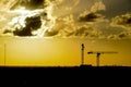 Construction cranes under a drmatic sky Royalty Free Stock Photo