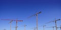 Construction cranes view over blue sky Royalty Free Stock Photo