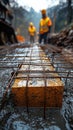 Construction crew laying reinforcement mesh on a road surface during infrastructural work. Royalty Free Stock Photo