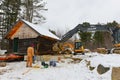 Construction crew moving log cabin on trailer