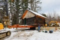 Construction crew unloading log cabin