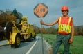 Construction crewman holding sign