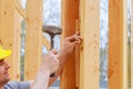 A construction day laborer carrying wood beams. Authentic construction worker on an actual construction site. Royalty Free Stock Photo