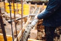 Construction details - worker laying cement or concrete with huge automatic pump