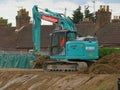 KOBELCO plantforce digger moving earth on construction site