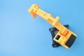 Construction digger tractor toy isolated on a blue background