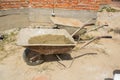Construction dirty wheelbarrow Royalty Free Stock Photo