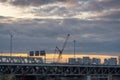 Construction at Dorogomilovsky road bridge. Yellow Crane. Dramatic cloudy sunset sky