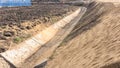 Construction of a drainage ditch along a road near an industrial facility