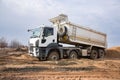 Construction dump truck performs excavation work on a construction site Royalty Free Stock Photo