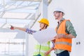 Construction engineer with architect team working check building construction progress at construction site Royalty Free Stock Photo