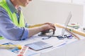 Construction engineer builder working at desk typing on laptop computer. People using mobility 5G Internet wireless connection