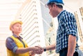 Construction and engineer concept. Construction worker in protective uniform shaking hands meeting