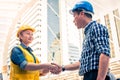 Construction and engineer concept. Construction worker in protective uniform shaking hands meeting for architectural project