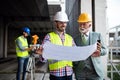 Construction engineer with foreman worker checking construction site