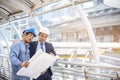 Construction engineer in Safety Suit Trust Team Holding White Yellow Safety hard hat Security Equipment on Construction Site. Royalty Free Stock Photo