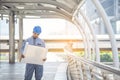 Construction engineer in Safety Suit Trust Team Holding White Yellow Safety hard hat Security Equipment on Construction Site. Royalty Free Stock Photo