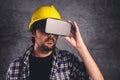 Construction engineer with VR goggles managing building project