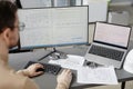 Construction engineer at workplace using computer with blueprints on screen Royalty Free Stock Photo