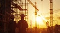 Construction Engineers Overlooking Site at Sunset Silhouette. Royalty Free Stock Photo