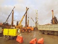 Construction equipment at the overpass repair site. large concrete blocks are erected by cranes. next to a large truck with a gray Royalty Free Stock Photo