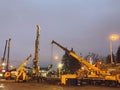Construction equipment at the overpass repair site. a tall, yellow, metal crane carries large concrete blocks. the repair site is Royalty Free Stock Photo