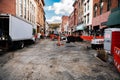 Construction equipment during road works in an urban environment between tall buildings Royalty Free Stock Photo