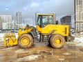 Construction equipment on site. building houses and laying roads. bright, yellow excavator for digging holes and laying plumbing Royalty Free Stock Photo