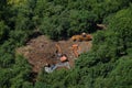 Construction equipment works in the forest among the trees - July 10, 2020, Moscow, Russia