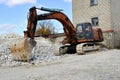 Construction excavator at an industrial gypsum stone processing plant. Mineral Loading Royalty Free Stock Photo
