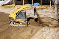 Construction excavator of yellow color on the earth moving scoop excavator