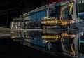 Construction excavator of yellow color and Old waters pumps with reflection on water Royalty Free Stock Photo