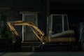 A construction excavator of yellow color for the construction site parked after finishing work. Grader and Excavator Construction Royalty Free Stock Photo