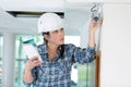 Construction female worker with ladder checking cctv installation