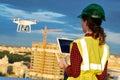 Drone inspection. Operator inspecting construction building site flying with drone Royalty Free Stock Photo