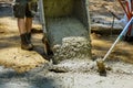 Construction filling formwork with cement worker pour cement for sidewalk on concrete with wheelbarrow Royalty Free Stock Photo