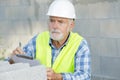 Construction foreman builder on building site clipboard Royalty Free Stock Photo