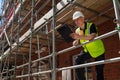 Construction Foreman Builder on Building Site Clipboard and Mug Royalty Free Stock Photo