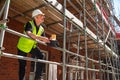 Construction Foreman Builder on Building Site Clipboard and Mug Royalty Free Stock Photo