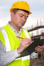 Construction foreman checks clipboard