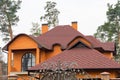 Construction frame house rain gutter system and brick chimney pipe on the asphalt roofing shingles top.